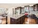 Modern kitchen featuring dark wood cabinetry, stainless steel appliances, and a granite-topped island at 11602 Pine Canyon Dr, Parker, CO 80138