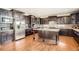 Spacious kitchen with dark cabinetry, stainless steel appliances, and a center island at 11602 Pine Canyon Dr, Parker, CO 80138