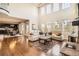 Open living room features tall ceilings, hardwood floors, and large windows at 11602 Pine Canyon Dr, Parker, CO 80138