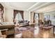 Spacious living room and dining area with hardwood floors, elegant decor, and natural light at 11602 Pine Canyon Dr, Parker, CO 80138