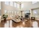 Sunlit living room with high ceilings, a stone fireplace, and expansive windows, creating a cozy atmosphere at 11602 Pine Canyon Dr, Parker, CO 80138
