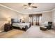 Spacious main bedroom features a ceiling fan, chair, and windows with valances at 11602 Pine Canyon Dr, Parker, CO 80138