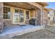 Covered patio with stone accents, stainless grill, and sliding door access to backyard at 11602 Pine Canyon Dr, Parker, CO 80138