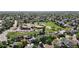 Aerial view of a residential neighborhood with green spaces, school, and tree-lined streets at 2980 E 135Th Dr, Thornton, CO 80241