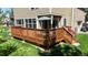 Expansive wood back deck perfect for outdoor entertaining with table, chairs, and a large sun umbrella at 2980 E 135Th Dr, Thornton, CO 80241