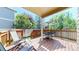 Relaxing covered back deck featuring comfortable lounge seating and an outdoor dining area with a sun umbrella at 2980 E 135Th Dr, Thornton, CO 80241