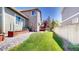 Spacious backyard showcasing a well-maintained lawn, planting beds, and a charming wooden fence at 2980 E 135Th Dr, Thornton, CO 80241