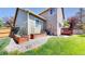 Backyard featuring raised garden beds, patio area, and green lawn at 2980 E 135Th Dr, Thornton, CO 80241