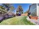 Large, green backyard with a wood fence and a garden area with raised beds ready for planting at 2980 E 135Th Dr, Thornton, CO 80241