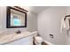 Clean half bathroom featuring granite countertop, framed mirror and wood floors at 2980 E 135Th Dr, Thornton, CO 80241