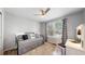 Bright bedroom with a ceiling fan, a large window with window treatments, and a cozy daybed at 2980 E 135Th Dr, Thornton, CO 80241