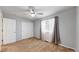 This bedroom features neutral colored carpet, a ceiling fan, double door closet, and natural light at 2980 E 135Th Dr, Thornton, CO 80241