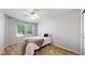 Neutral bedroom with a ceiling fan, a large window with window treatments, and a comfortable bed at 2980 E 135Th Dr, Thornton, CO 80241