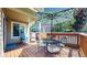 Outdoor deck with a patterned umbrella over a metal dining set, and additional seating at 2980 E 135Th Dr, Thornton, CO 80241