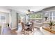 Bright dining area featuring a round table, upholstered chairs, and sliding glass doors to the deck at 2980 E 135Th Dr, Thornton, CO 80241