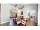 Bright dining room with a modern chandelier, wood floors, and stylish seating at 2980 E 135Th Dr, Thornton, CO 80241