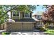 Charming two-story home features a well-manicured lawn, brick accents and attached two-car garage at 2980 E 135Th Dr, Thornton, CO 80241