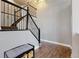 Foyer with staircase and bench, featuring stylish black railings and wood floors at 2980 E 135Th Dr, Thornton, CO 80241