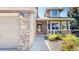 Home exterior featuring brick, a two-car garage, and landscaped entry way at 2980 E 135Th Dr, Thornton, CO 80241