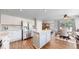 Modern kitchen features an island, stainless steel appliances, wood flooring and ample cabinet space at 2980 E 135Th Dr, Thornton, CO 80241