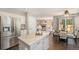 Open kitchen featuring stainless steel appliances, granite countertops, and an adjacent dining area at 2980 E 135Th Dr, Thornton, CO 80241