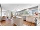Bright kitchen features an island, stainless steel appliances, and access to the dining area at 2980 E 135Th Dr, Thornton, CO 80241