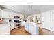 Bright kitchen features stainless appliances, large island, and white cabinets at 2980 E 135Th Dr, Thornton, CO 80241
