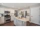 Stylish kitchen features stainless steel appliances, white cabinets, and a gray center island at 2980 E 135Th Dr, Thornton, CO 80241