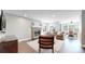 Open-concept living space with fireplace, wood floors, comfortable seating and dining area at 2980 E 135Th Dr, Thornton, CO 80241