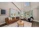 Bright living room featuring high ceilings, many windows, hard wood floors, and comfortable seating at 2980 E 135Th Dr, Thornton, CO 80241