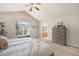Bright main bedroom featuring high ceilings, ceiling fan, large window, and ensuite access at 2980 E 135Th Dr, Thornton, CO 80241