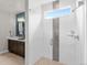 Bright bathroom features a glass shower with stylish gray-tone mosaic tiles, and a view from the window at 6244 N Lisbon St, Aurora, CO 80019