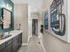Bathroom featuring double sinks, dark cabinets and access to the glass enclosed shower stall at 6244 N Lisbon St, Aurora, CO 80019