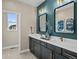 Bathroom with double sinks, dark cabinets, gold hardware, and lovely decor at 6244 N Lisbon St, Aurora, CO 80019