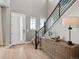 Bright and airy foyer with wood floors, staircase, and plenty of natural light at 6244 N Lisbon St, Aurora, CO 80019
