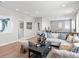 Spacious upper-level hallway with a modern sofa and ample natural light streaming in from the windows at 6244 N Lisbon St, Aurora, CO 80019