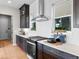 Bright kitchen features dark cabinets, white countertops, and a stylish stainless steel range hood at 6244 N Lisbon St, Aurora, CO 80019