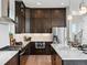 Well-equipped kitchen featuring stainless steel appliances, dark wood cabinets and marble countertops at 6244 N Lisbon St, Aurora, CO 80019