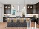 Spacious kitchen island with seating, pendant lighting, and custom cabinetry at 6244 N Lisbon St, Aurora, CO 80019