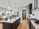 Open kitchen with an island and adjacent dining and living area featuring hardwood floors and modern finishes at 6244 N Lisbon St, Aurora, CO 80019