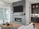 Stylish living room featuring a contemporary fireplace and ample natural light from the sliding doors at 6244 N Lisbon St, Aurora, CO 80019