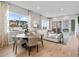 Inviting living room and dining area with large windows providing lots of natural light at 6244 N Lisbon St, Aurora, CO 80019