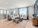 Open-concept living room with stylish decor, a comfortable sofa, and plenty of natural light at 6244 N Lisbon St, Aurora, CO 80019