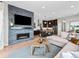 Open-concept living room with a cozy fireplace, adjacent kitchen, and a stylish design at 6244 N Lisbon St, Aurora, CO 80019