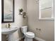 Elegant powder room with modern fixtures, stylish mirror, and hexagon flooring at 6244 N Lisbon St, Aurora, CO 80019