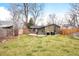 Spacious backyard with a lush lawn, wooden fence, patio, and grill at 1232 Wabash St, Denver, CO 80220