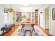 Stylish dining room with custom shelves, brick detail, and seating for four, plus hardwood floors at 1232 Wabash St, Denver, CO 80220