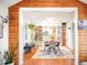 Open-concept living space with dining area featuring built-in shelves and flow to living area at 1232 Wabash St, Denver, CO 80220