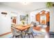 Open dining area with modern table, colorful rug, wood floors, and seamless flow to living room at 1232 Wabash St, Denver, CO 80220