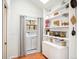 Functional laundry area with shelving for storage and a modern washer and dryer at 1232 Wabash St, Denver, CO 80220